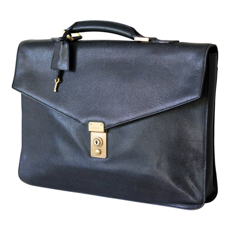 Angled front view of a vintage Chanel black caviar leather portfolio with top handle, gold-tone lock and hanging key