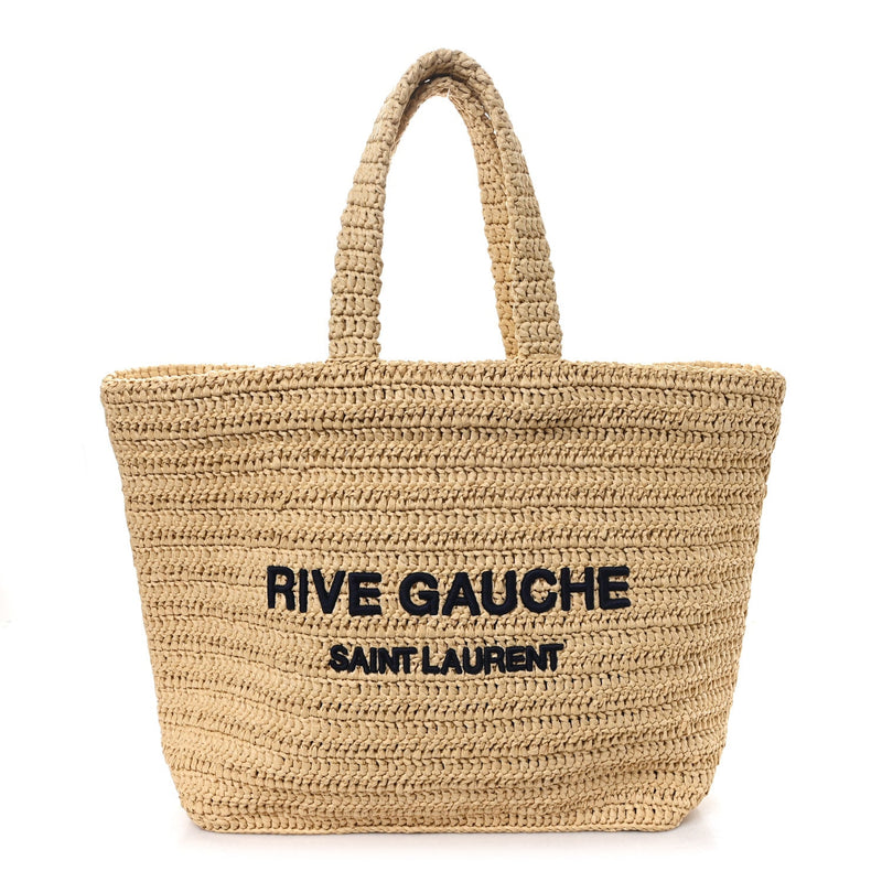 Front view of a Saint Laurent Rive Gauche natural raffia tote with navy lettering and two woven handles